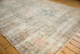 Distressed Sparta carpet border and field, showcasing faded ivory, ocean green, and blush floral vinery.