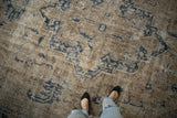 Distressed Turkish Sparta rug, dusty navy geometric pattern, visible foundation wear.