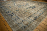 Textured vintage Sparta rug with faded navy, antique ivory, and platinum botanical patterns.