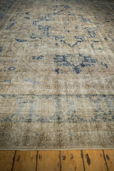 Geometric dusty navy patterns and visible foundation wear on a distressed Sparta rug.