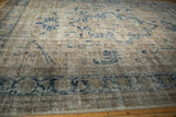 Distressed texture of a vintage Sparta rug featuring dusty navy vines and beige border.