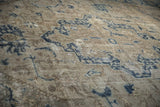 Distressed Sparta carpet with worn geometric dusty navy and beige motifs.