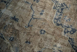 Distressed texture, worn knot heads, and navy blue patterns on a vintage Sparta carpet.