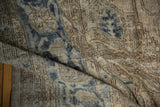 Distressed hand knotted Sparta carpet texture with visible foundation and soft navy blue tones.