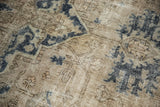 Worn knot heads and time-softened navy motifs on vintage Sparta carpet pile.
