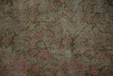 Vintage distressed Karabagh rug's expressive faded pink floral motifs and even wear.
