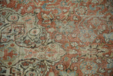 Distressed texture of Mahal rug, revealing faint foundation, dusty brick and sage floral design.