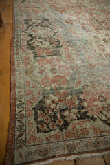 Distressed Mahal rug corner, with dusty brick selvage, faded floral design, and fringe.