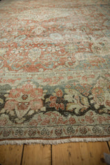 Terracotta, ivory, and green floral motifs on the distressed Mahal carpet's worn pile.