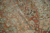 Distressed Mahal carpet texture with low pile, showing dusty brick, ivory, and blue floral motifs.