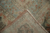 Vintage distressed Mahal rug folded corner, showing worn pile, subtle hues, and visible foundation.