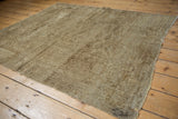 Distressed vintage Turkmen rug with worn pile and visible foundation.