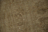 Close-up of vintage distressed Turkmen rug's worn pile, subtle gul motifs, and exposed foundation.
