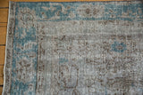 Textured surface of a distressed Turkish Oushak with wear showing the foundation and knot heads.
