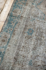 Detailed texture of the distressed Oushak carpet with foundation showing through the low pile.