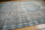 A close-up of the distressed Oushak carpet's texture, showing mostly even wear to the foundation.