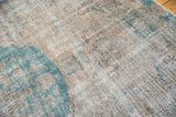 Distressed pile on a vintage Oushak showing mostly even wear to the knot heads and foundation.