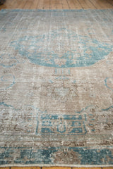 A low-angle view showing the time-softened pile of a distressed vintage Oushak carpet.