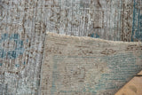 Back of the vintage Oushak rug, showing the hand-knotted weave and secured side cord selvage.