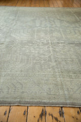 Surface texture of the distressed Oushak carpet, showing even wear and subtle geometric motifs.
