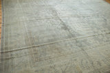 Textured pile and even wear of vintage Oushak rug in faded silver, ivory, and beige.