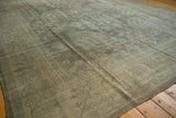 Textured distressed Oushak rug pile, showing softened geometric tree-of-life in silver-beige.