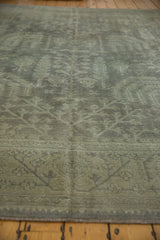 Textured vintage Oushak rug pile with geometric motifs in time-softened silver and dusty beige.