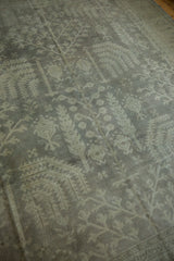 Distressed Oushak carpet detail, showing even wear and faded geometric tree motifs.