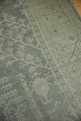 Distressed Oushak carpet pile showing even wear to knot heads, muted silver tones.