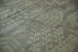 Distressed vintage Oushak pile with faded silver and beige tree of life motifs.