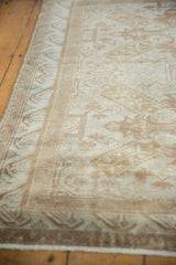 Distressed Sivas rug border showcasing softened ivory and sand tones with wave patterns.