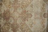Distressed vintage Sivas rug showcasing textured brown, ivory floral patterns with even wear.