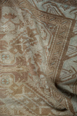 Distressed pile texture revealing muted tones and subtle floral motifs of the vintage Sivas rug.