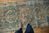 Distressed Hamadan runner with even wear, featuring dusty ocean green and sand patterns.