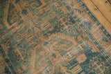 Distressed vintage Hamadan runner texture in dusty green and gold, with exposed foundation.