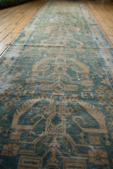 Distressed vintage Hamadan runner displaying a faded tree of life motif in ocean green and beige.