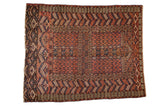 Antique Turkmen Hatchli rug with an intricate geometric design in madder red, navy blue, and chestnut brown.