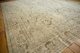 Distressed vintage Oushak rug displaying ivory field, brown floral motifs, and noticeable foundation wear.