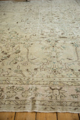Distressed vintage Oushak carpet with worn pile, highlighting faint ivory, brown, and oxidized silver floral motifs.
