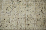 Distressed Oushak rug texture, showing faded floral motifs and visible foundation from wear.