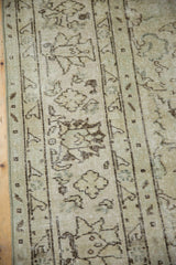 Distressed Oushak rug, ivory and dark chocolate floral vinery with subtle silver tones.