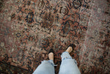 Distressed vintage Persian Bibikabad rug, Harshang and Herati motifs in pale raspberry, navy, ivory.