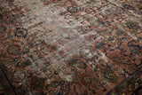 Distressed Bibikabad carpet section, featuring faded raspberry, navy, and ivory floral patterns with foundation wear.
