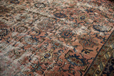 Decorative distressed Persian Bibikabad rug with faded raspberry, navy, ivory Herati-Harshang pattern.