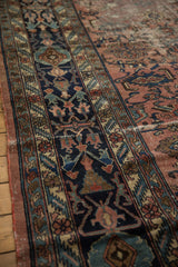 Distressed vintage Bibikabad carpet border with navy palmettes and floral vines on a raspberry field.