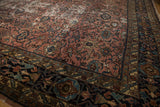 Dark navy border with palmette motifs, merging into the distressed raspberry Bibikabad field.