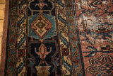 Distressed vintage Bibikabad rug with worn pale raspberry field, exposed foundation, and ornate navy border.