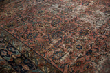 Distressed Persian Bibikabad carpet, pale raspberry field, navy Herati motifs, prominent foundation wear.
