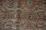 Distressed Hamadan runner pile showing worn Herati motifs in faded terracotta and oxidized silver tones.
