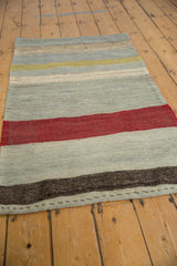 Hand woven vintage Turkish Kilim flatweave, showing charcoal, blue-grey abrashes, and secured edge.